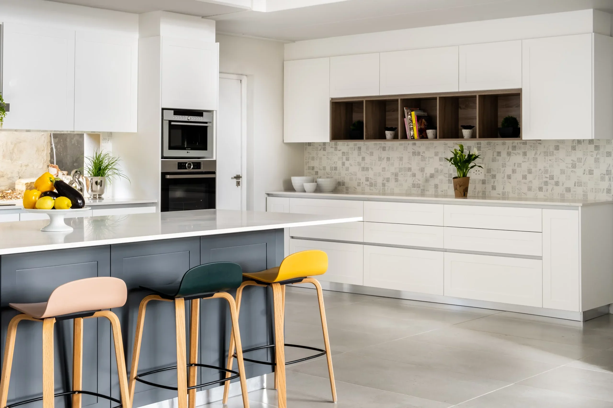 This contemporary kitchen showcases stunning shaker doors with Gola handles to tie everything together.